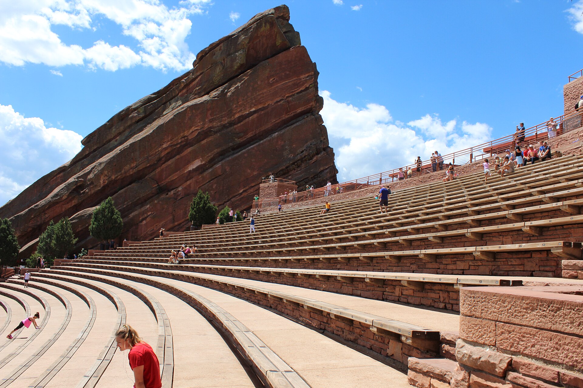 Red Rocks Amphitheatre in Colorado: a giant red sandstone monolith towering over rows of seating.